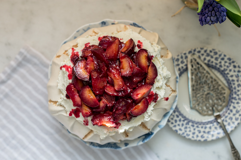 Delicious Pavlova with salted, bakes plums.